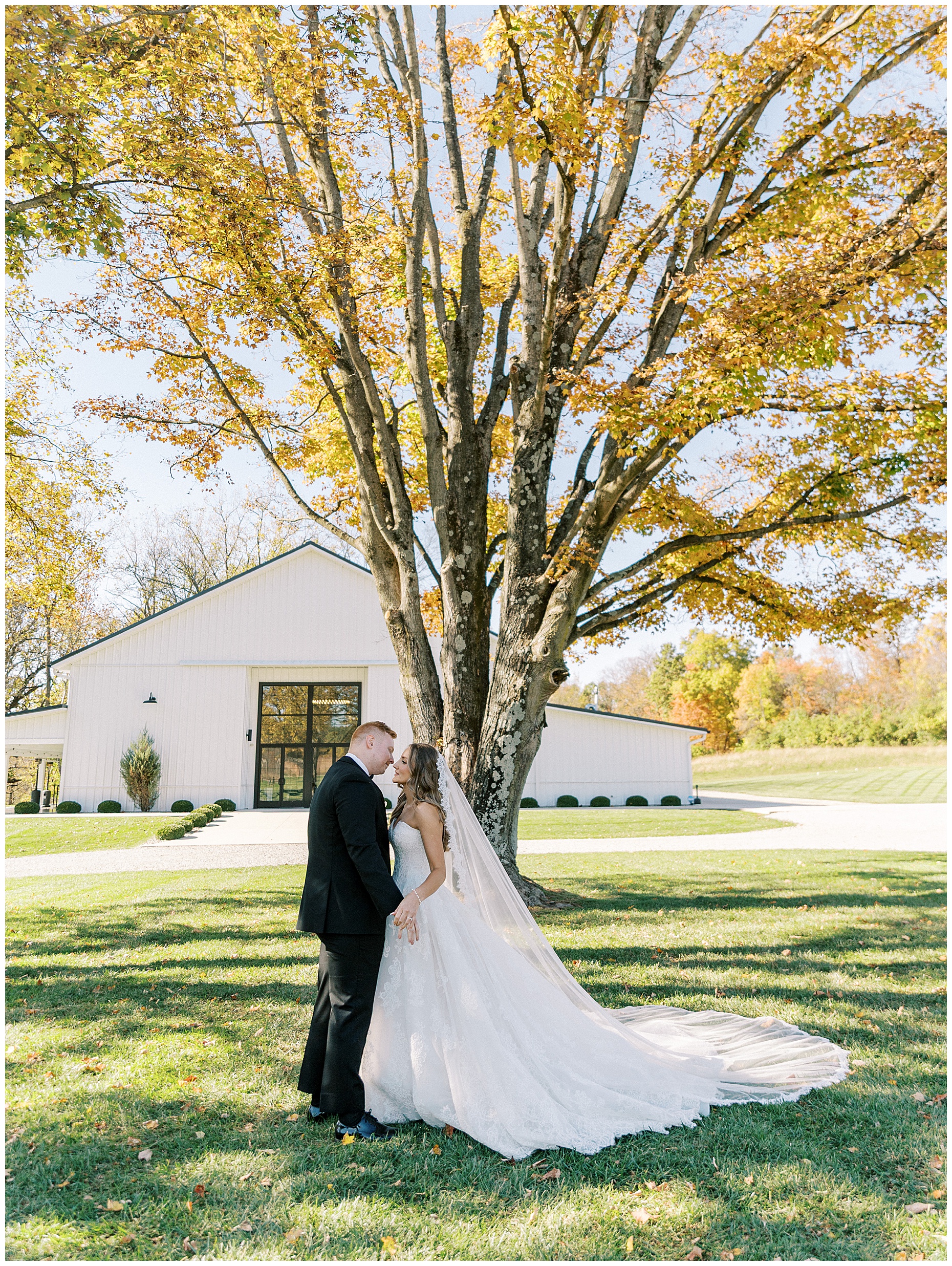 A heartfelt Cliffside Acres wedding featuring fall foliage, classic black and white details, and Lindsey and Sam's ceremony and reception