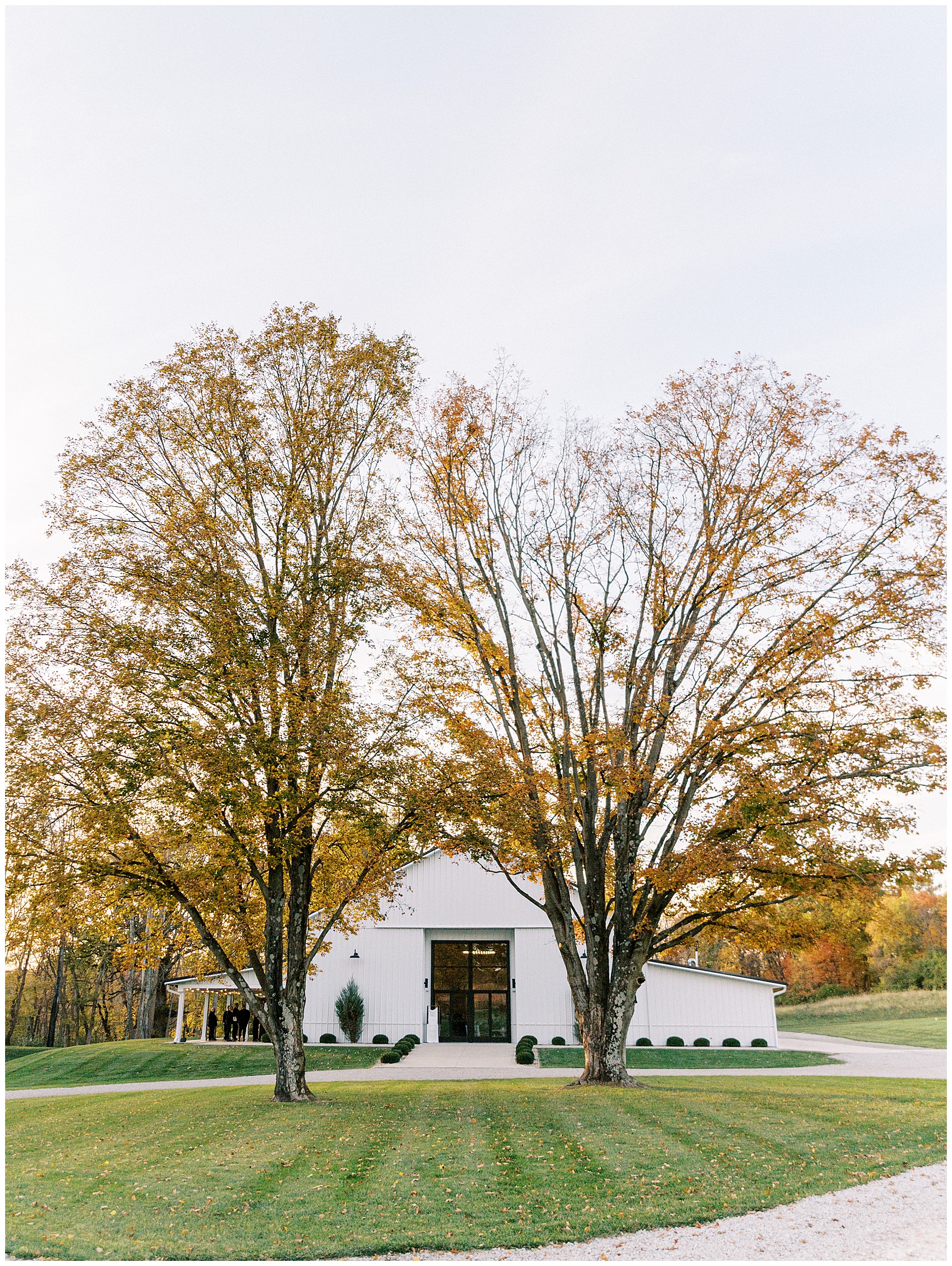 A heartfelt Cliffside Acres wedding featuring fall foliage, classic black and white details, and Lindsey and Sam's ceremony and reception